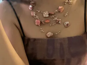 Detail view of the multi-layer irregular pink shell necklace, featuring elegant vacation style.