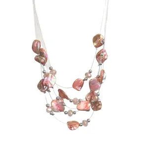 Detailed shot of multi-layer irregular pink shell crystal bead necklace vacation style fashion.
