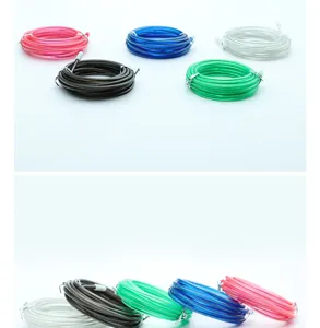 Detailed close-up of colorful steel wire jump rope replacement cables with protective sleeves.