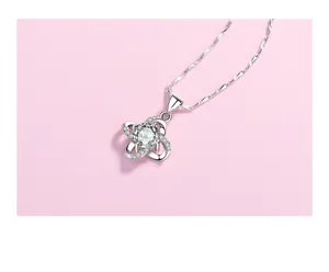 Detail shot of S925 silver four leaf clover pendant necklace with sparkling diamond-set stones.