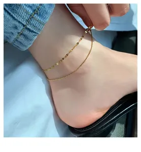 Delicate double layer anklet close-up, faceted beads design, stylish foot jewelry detail.