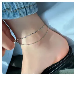 Silver double layer anklet detail featuring dainty lip beads and sparkling starry chains.