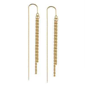 Boucles d'oreilles pendantes en argent S925 plaqué or avec de longs glands scintillants.