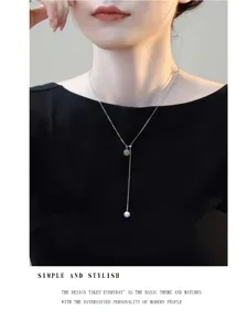 Close-up detail of silver necklace featuring Hetian jade and pearl double bead pendant design.