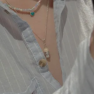 Layered silver necklace with blue heart and vintage cake pendant for women trendy jewelry.