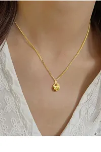 Close-up detail of sterling silver lucky lock pendant necklace, elegant Chinese style chain.