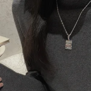 S925 sterling silver minimalist pendant necklace detail shot, vintage style jewelry piece.