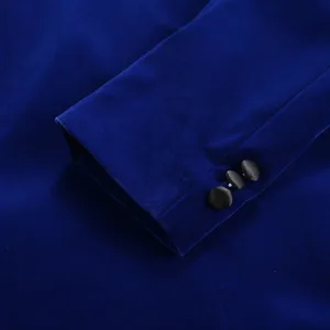 Blue velvet suit jacket sleeve detail showing elegant cuff with three black buttons.