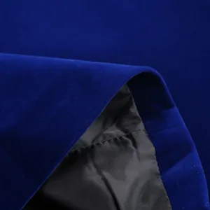 Velvet suit fabric detail close-up showing royal blue texture and black inner lining.