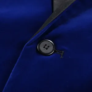 Close-up detail of blue velvet suit blazer lapel and black button texture display.