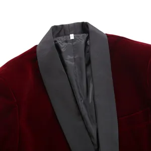 Close-up detail of the burgundy velvet men's blazer featuring a contrasting black shawl lapel.