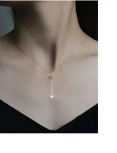 Detailed close-up shot of the exquisite double-bead pearl and jade pendant necklace.
