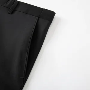 Men's black dress pants detail closeup, classic trousers waistband and pocket design.