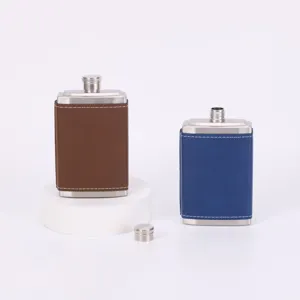 Portable stainless steel hip flask with removable leather cover for outdoor travel use.