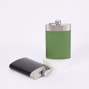 Stainless steel pocket hip flask detail view, portable flask in black and green colors.