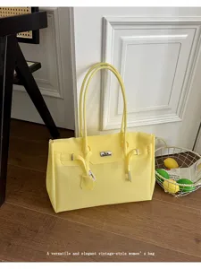 Yellow jelly tote bag detail, stylish women's shoulder bag in a clean lifestyle scene.