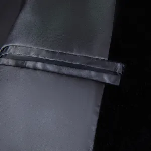Close-up detail of black velvet men suit jacket pocket craft and lining texture fine workmanship.