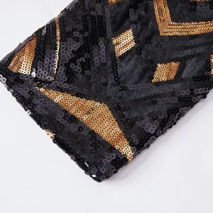 Detailed close-up view of black and gold sequin fabric on a men's fashion suit jacket sleeve.
