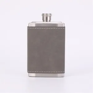 Stainless steel hip flask detail view, grey leather wrap and clean stitching finish.