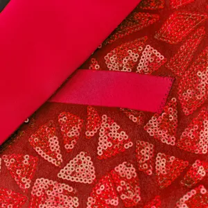 Men's red sequin suit jacket fabric detail, elegant geometric pattern for party evening wear.