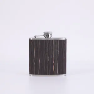 Stainless steel pocket flask wood grain texture detail view close up metal cap accessory