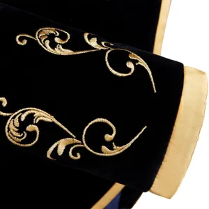 Men's black velvet suit jacket detail with gold embroidery and court style sleeve cuff design.