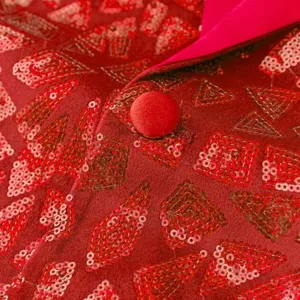 Close-up detail of men's red sequin blazer jacket, showing intricate pattern and fabric texture.