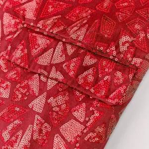 Close-up detail of men's red sequin blazer featuring geometric triangle patterns and pocket flap.