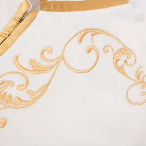 Close-up detail of white velvet jacket with gold baroque embroidery and collar design.
