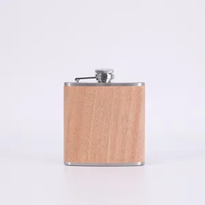 Stainless steel hip flask detail showing the wood grain wrap and cap design for outdoor use.
