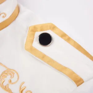 White and gold prince jacket detail close-up showing fine embroidery and shoulder epaulet design.
