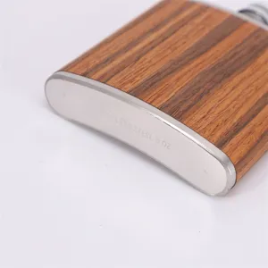 Stainless steel hip flask detail view, portable 6 oz pocket whiskey flask with wood grain finish.