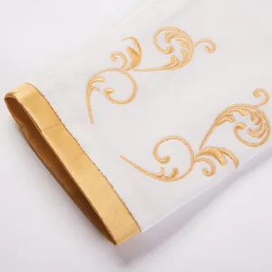 Close-up detail of white and gold embroidered court style jacket cuff, elegant luxury design.