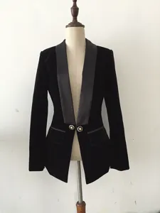 Detail view of black velvet blazer, satin shawl lapel, and gold embossed buttons.