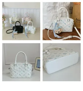Detailed view of the cute cartoon print shoulder bag with plush bear pendant, stylish handbag.