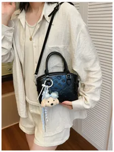 Korean style black cartoon print crossbody bag with cute plush charm for women fashion daily use.