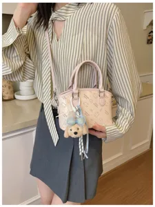 Korean style pink shoulder crossbody bag with cute cat print and fluffy puppy charm for women.