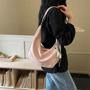Stylish pink slouchy shoulder bag for women, trendy hobo dumpling crossbody bag.