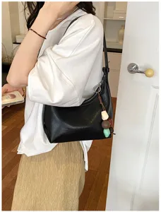 Minimalist black underarm hobo bag for women, stylish shoulder bag for daily casual wear.