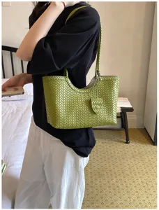 Detailed shot of the green woven leather tote bag showcasing premium texture and large capacity.