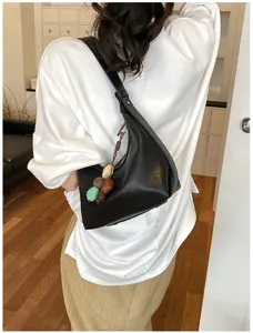 Minimalist black underarm shoulder bag for women, chic hobo messenger bag with charm.