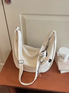 White PU leather crescent shoulder bag casual crossbody dumpling bag with cute horse charm.