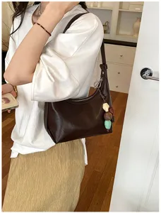 Minimalist brown leather underarm bag for women, chic stylish shoulder and crossbody purse.