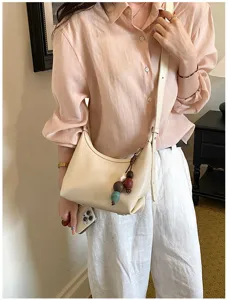 Minimalist chic underarm shoulder bag for women, stylish PU leather crossbody bag with beaded charm.