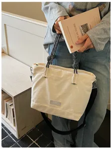 Casual canvas tote bag with rope handles and shoulder strap, large capacity daily commuter bag.