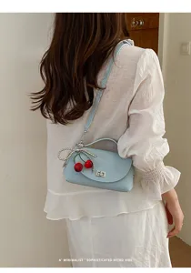 Light blue shoulder crossbody bag with pearl cherry charm, stylish women's chic small bag.