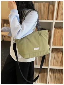 Casual large capacity canvas tote bag for women, stylish commuting shoulder crossbody bag.