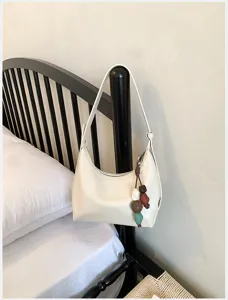 Minimalist white shoulder bag detail, chic casual daily crossbody bag with beaded pendant.