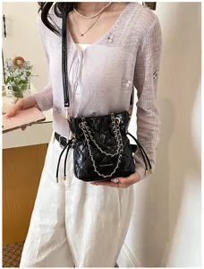 Black quilted chain bucket bag for women, stylish crossbody shoulder bag with drawstring.