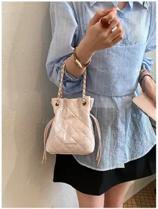 Pink quilted bucket bag with chain strap, stylish shoulder bag for women daily commuting.